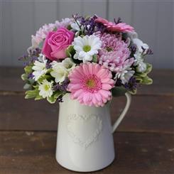 Jug of pretty pastel blooms 