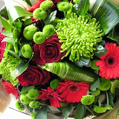 Hand tied bouquet in rich reds and greens 